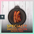 Fried Nitrite-free Smoked Bacon placed on top a stone grill pan, on a wooden background.