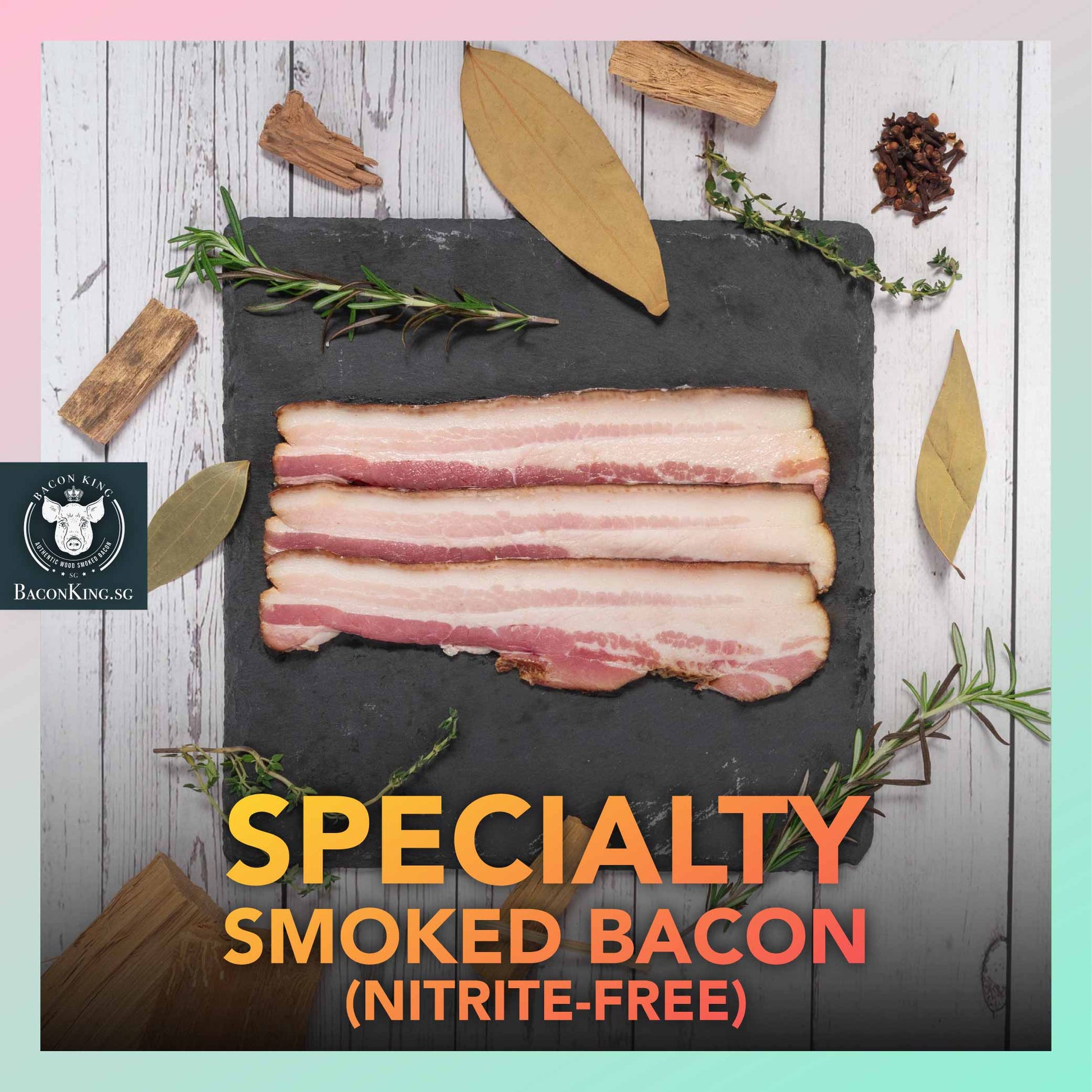 Slices of Nitrite-free Specialty Smoked Bacon on Stone Plate with Bay Leaves, Rosemary, Thyme, Cloves, Applewood chips decorating the side, against a marble background