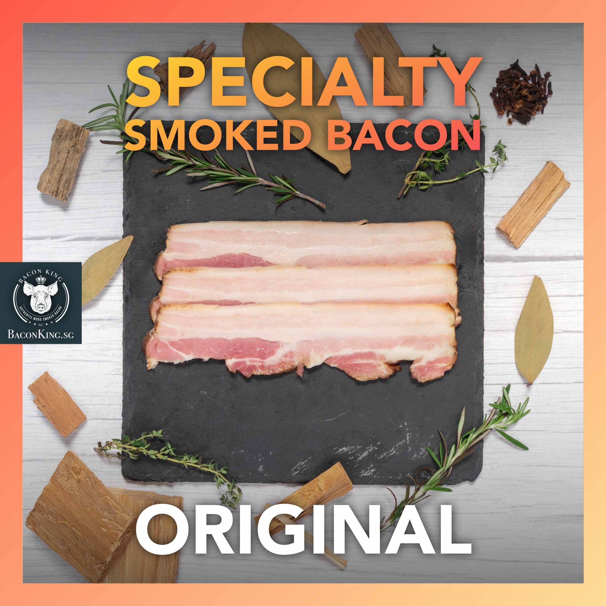 Slices of Specialty Smoked Bacon on Stone Plate with Bay Leaves, Rosemary, Thyme, Cloves, Applewood chips decorating the side, against a marble background